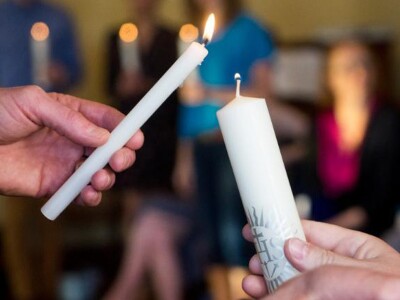 Lighting candles during a prayer service.