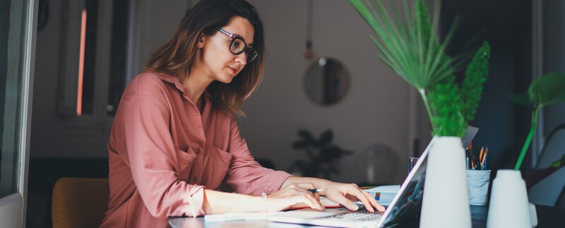 Young focused woman on laptop