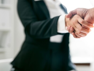 Close-up of two business executives shaking hands in an office