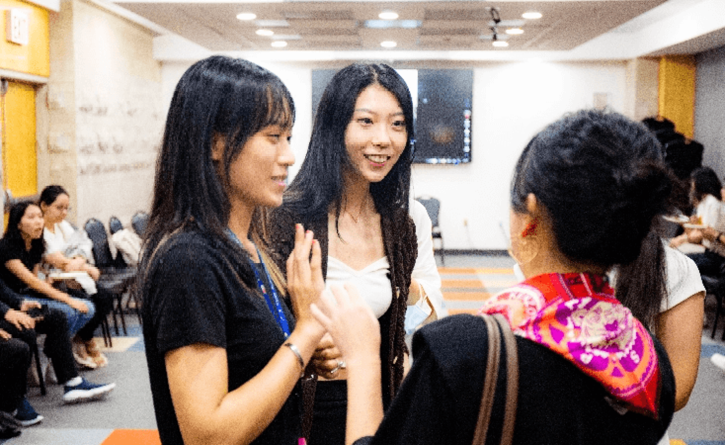 Three women in classroom talking