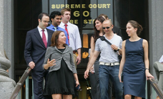 group of people talking while leaving the supreme court building