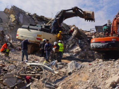 heavy excavator equipment being used to evacuate and search for earthquake victims