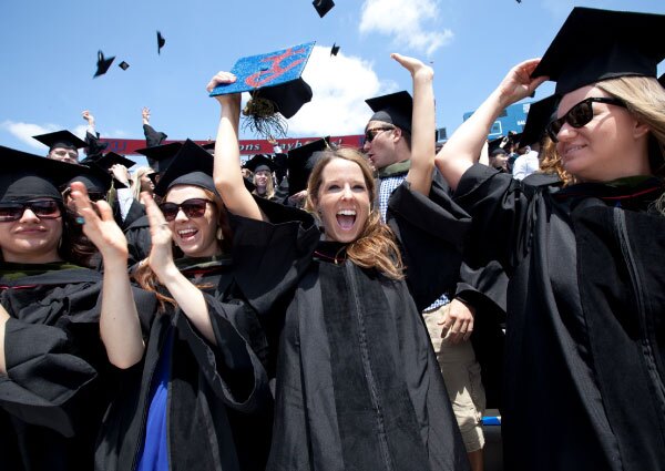 KU Graduates celebrate in cap and gowns