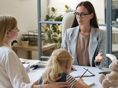 mother and young child doing in office visit with social worker