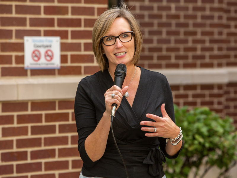 Woman speaking outdoors with microphone