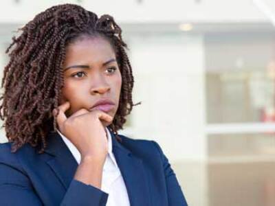 woman in business suit looking concerned