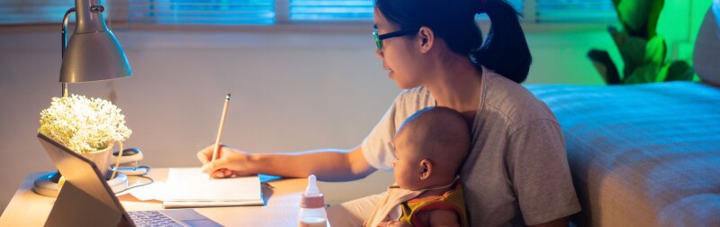 Asian mother and child Sitting and working at home at night