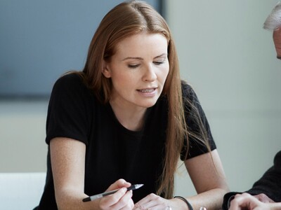 Business people in meeting reviewing paperwork