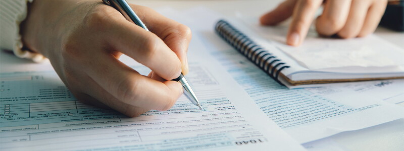 Close-up shot of someone filling out a 1040 form.