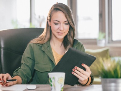 woman using tablet and laptop