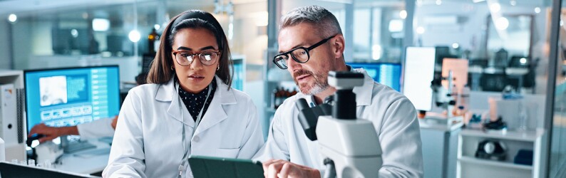Two people in lab together conducting research
