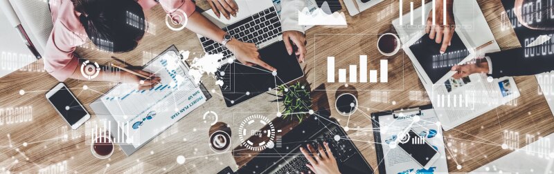 Imaginative group of marketing professionals reviewing brand strategy, utilizing marketing tools.