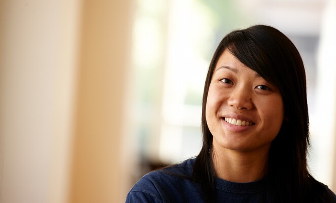 Marquette student with short black hair smiles at the camera