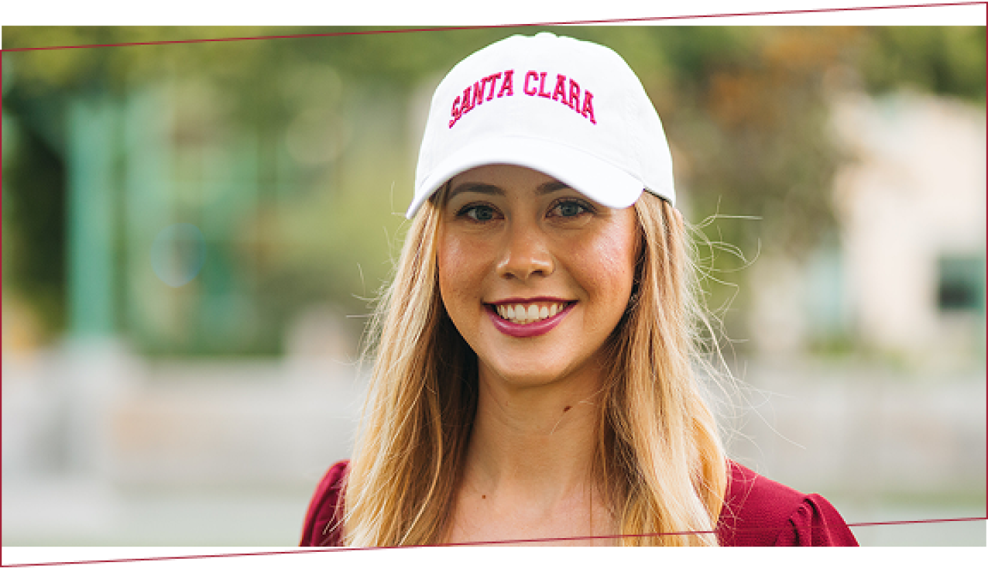 SCU graduate wearing a Santa Clara hat