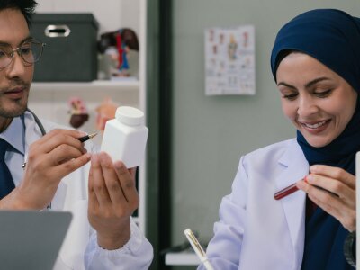 Doctor team, analysis the blood test examination results and medication usage of the patient on the chart, medical check-up concept.