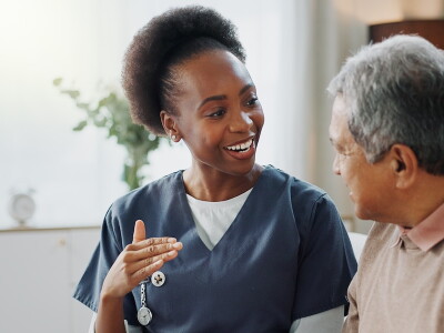 An Allied Health professional enjoys a conversation with a patient