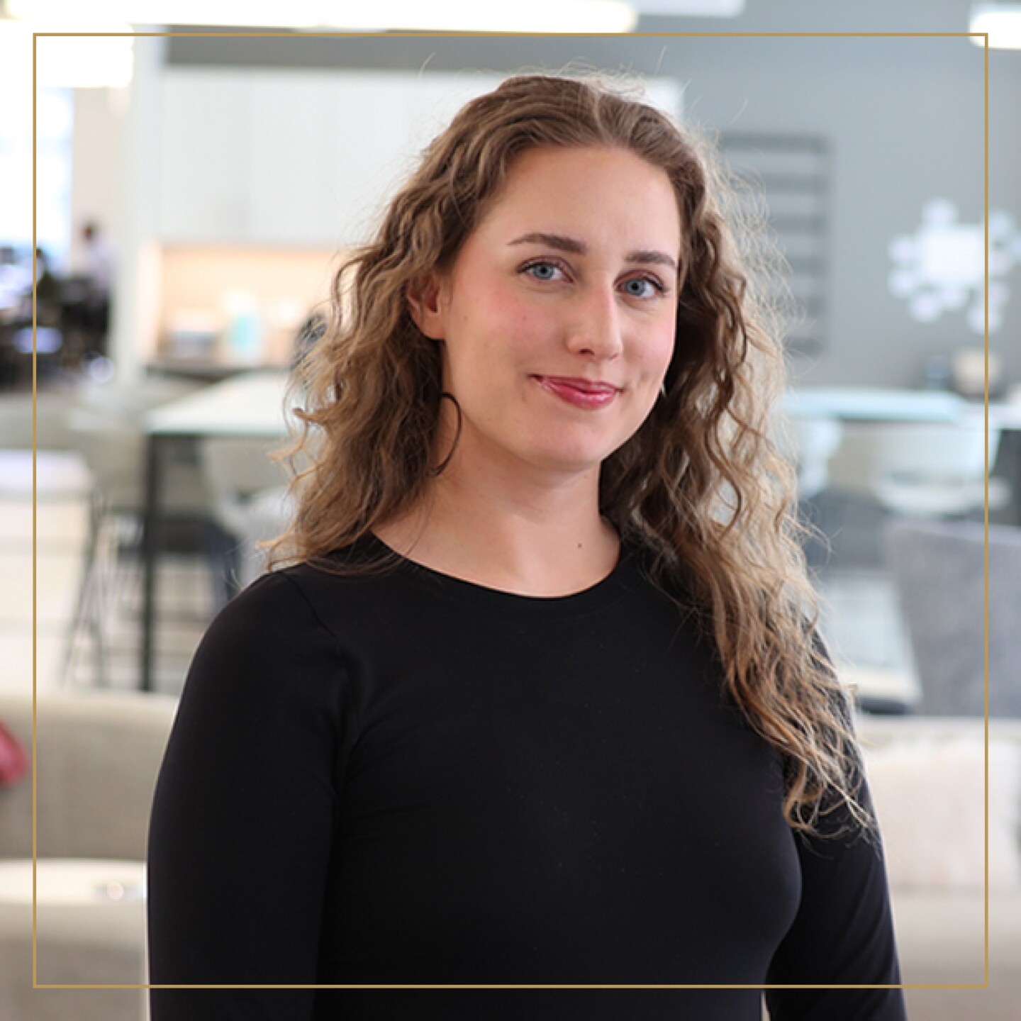 Smiling woman with long hair and black shirt