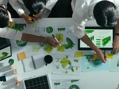 room of engineers planning with tablets and charts