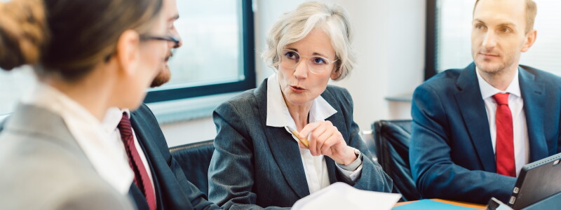 Professionals discussing legal and ethical issues during a meeting