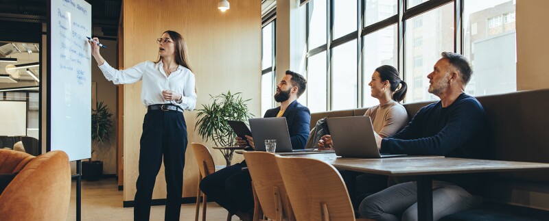 Female manager giving a presentation to her team