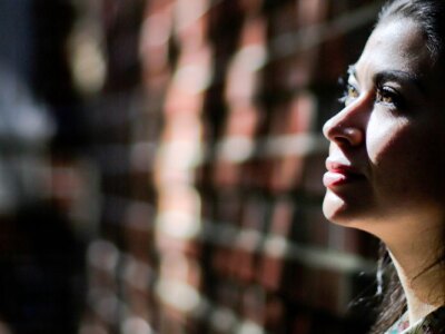 Potential female student contemplates attending college after an open house.