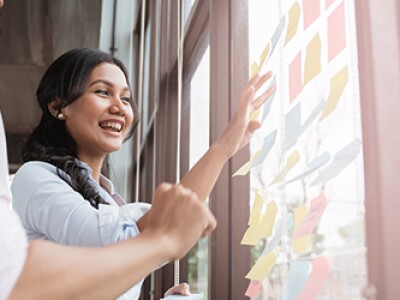Two coworkers working on business plan in office