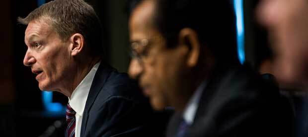 Two men at table one in focus and distressed