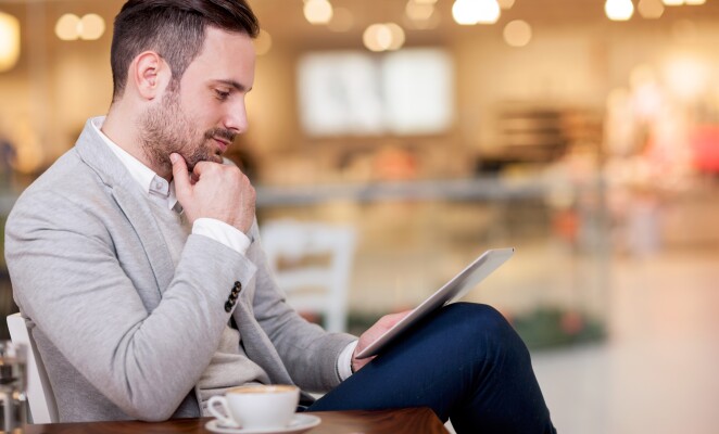 young businessman working on a digital tablet in a cafe