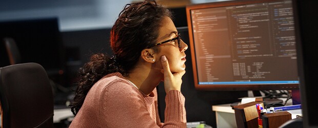 engineering student pensively looking at her desktop screen
