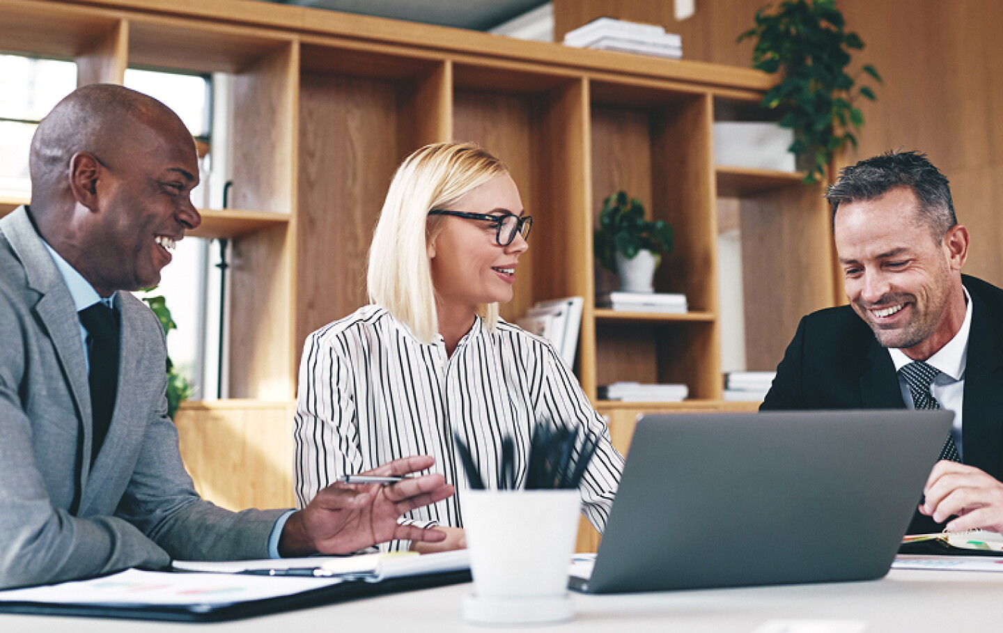 three business people reviewing data in a conference room