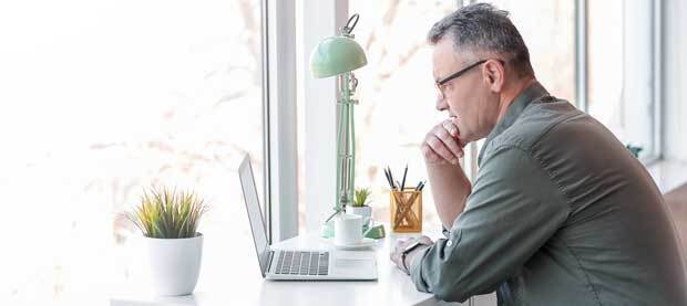 man-with-glasses-learning-on-a-computer