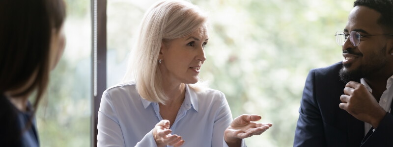 Businesswoman leads a meeting of attentive colleagues