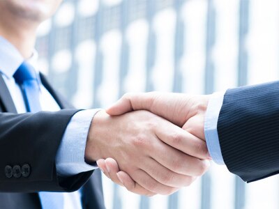 Two business professionals shaking hands, symbolizing a successful agreement or ethical partnership.