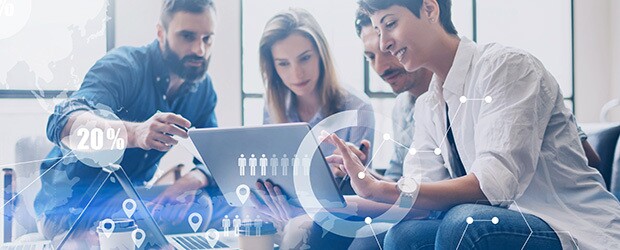 Colleagues review a dashboard display on a laptop computer