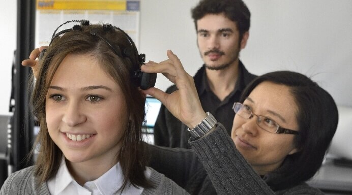 Engineer fitting woman for headset