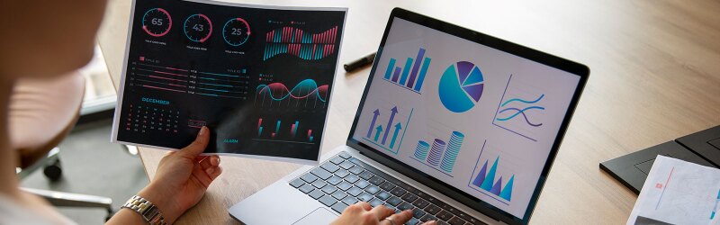A person reviewing statistical patterns on a laptop
