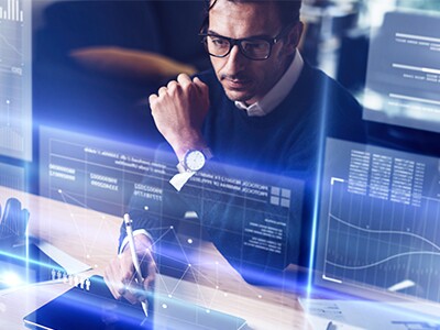 Man working on futuristic computer with multiple screens