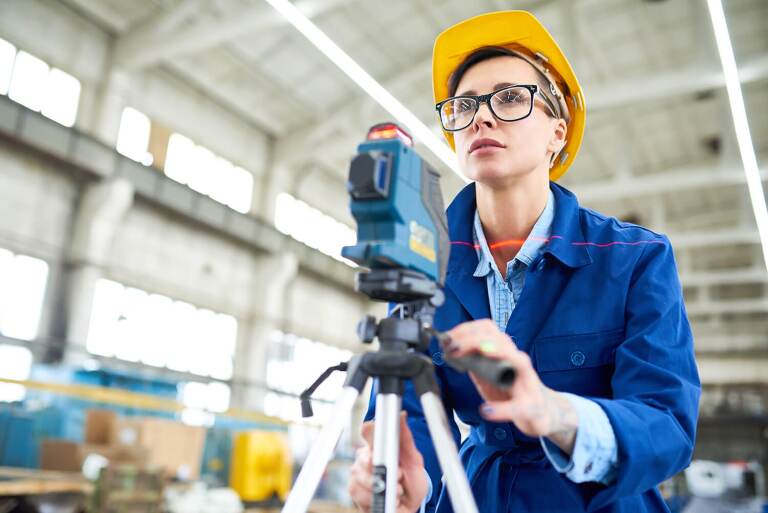 Woman with surveying device