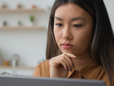 Businesswoman working from home and contemplating a decision