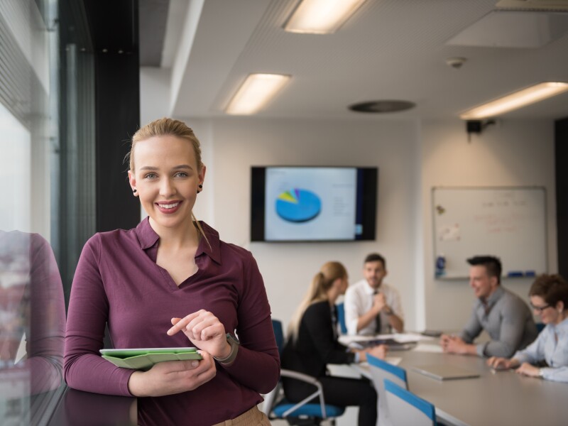 blonde business woman working on tablet at office