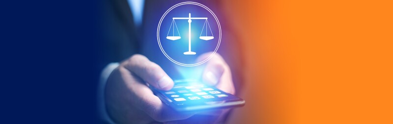 Man's hands holding a cellphone with the scales of justice projected off the screen.