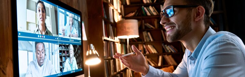 Business man having virtual team meeting on video conference call using computer.