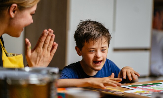 Boy with school counselor working on a lesson
