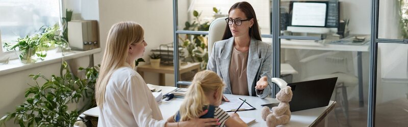 mother and young child doing in office visit with social worker