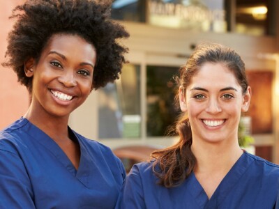 Portrait of a group of nursing professionals standing outside hospital.