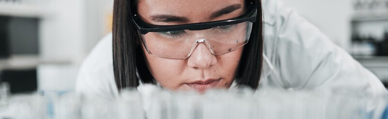 Biomedical engineer looking thoughtfully at her work
