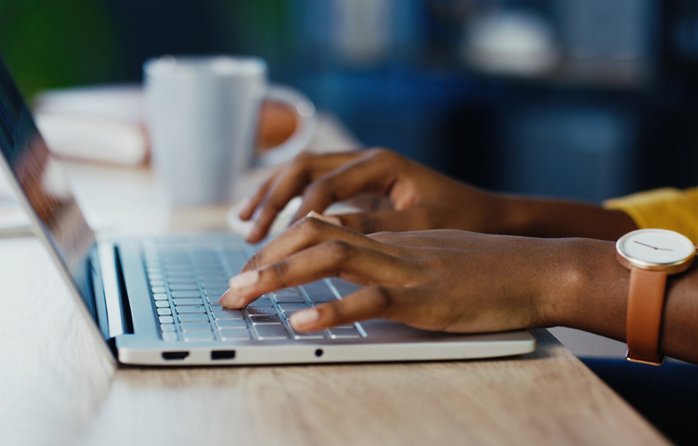 Close up shot of female hands typing on laptop
