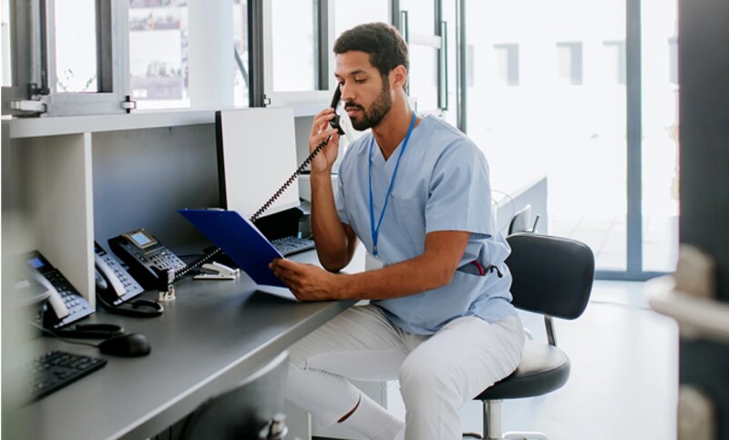 Nurse taking a phone call at the nurse’s station