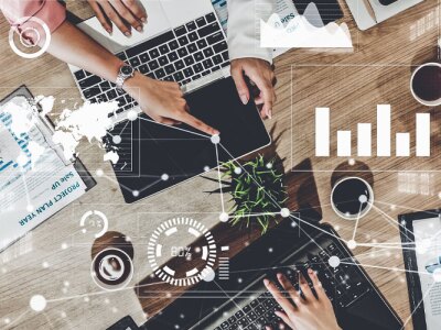 Imaginative group of marketing professionals reviewing brand strategy, utilizing marketing tools.