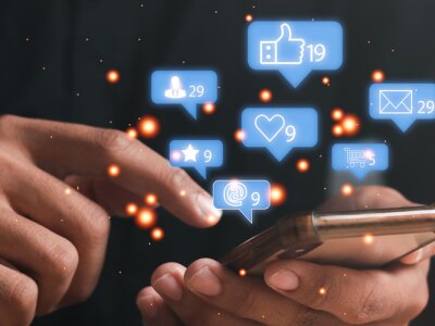 Man using a social media marketing concept on mobile phone with notification icons.